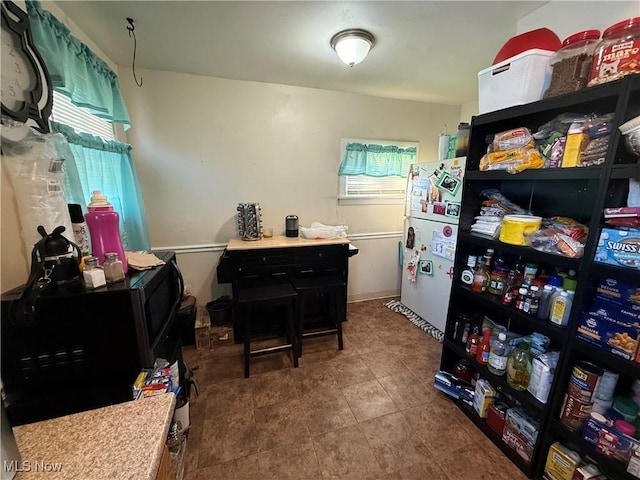 interior space featuring white fridge and a wealth of natural light