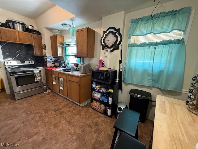 kitchen with tasteful backsplash and stainless steel electric stove