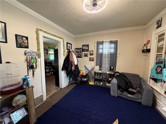 misc room with dark carpet, a textured ceiling, and crown molding