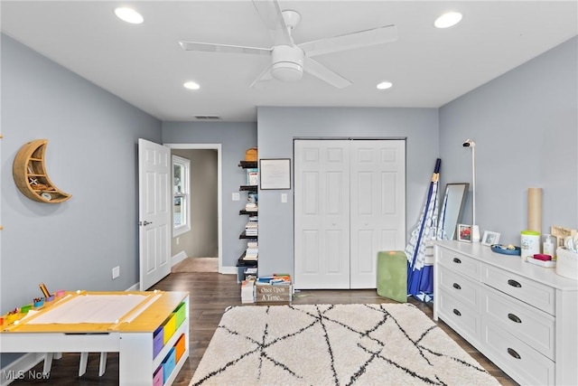 rec room with ceiling fan and dark wood-type flooring