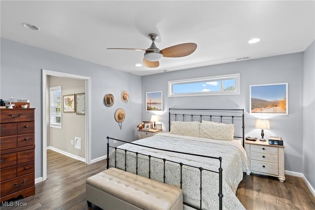 bedroom with ceiling fan and dark hardwood / wood-style flooring