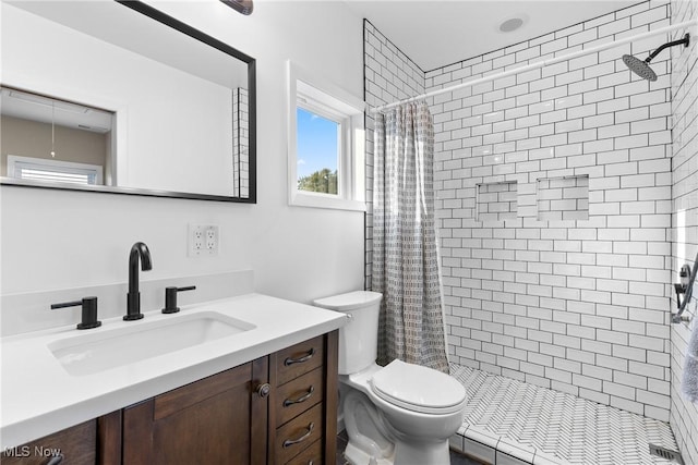 bathroom featuring curtained shower, toilet, and vanity