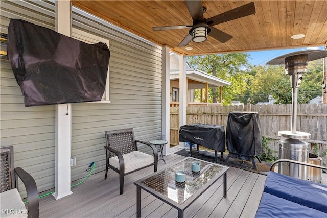 wooden terrace featuring ceiling fan and area for grilling