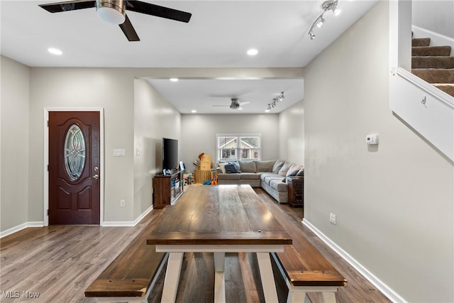 entrance foyer with ceiling fan, rail lighting, and hardwood / wood-style floors