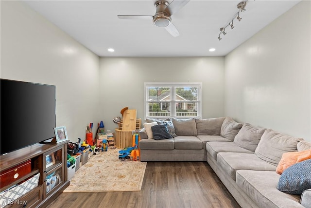 living room with ceiling fan, dark hardwood / wood-style floors, and track lighting