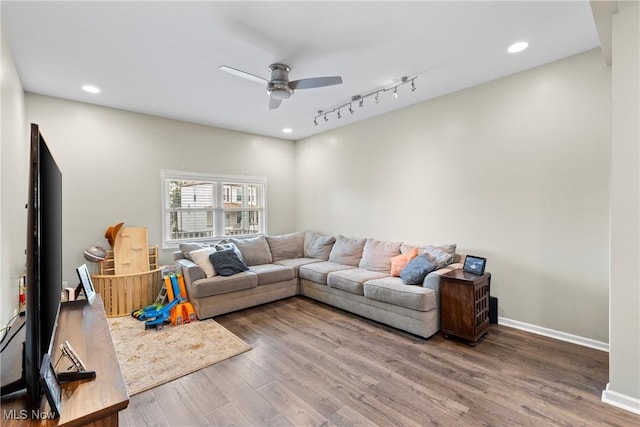 living room featuring ceiling fan, rail lighting, and hardwood / wood-style floors