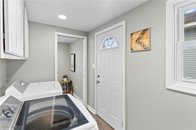 washroom with washing machine and dryer and cabinets