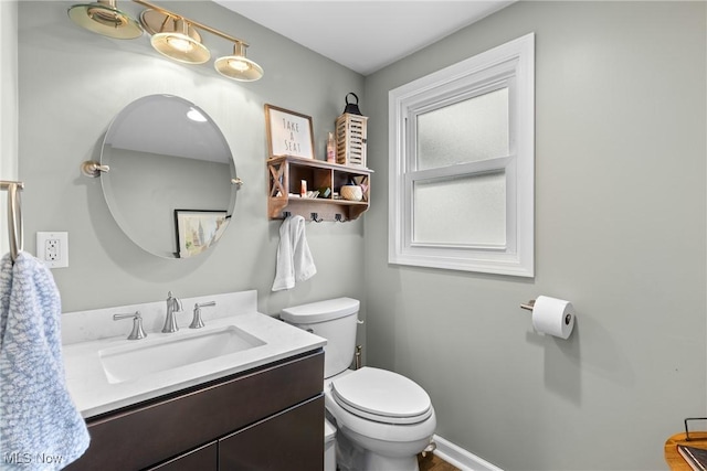 bathroom featuring toilet and vanity