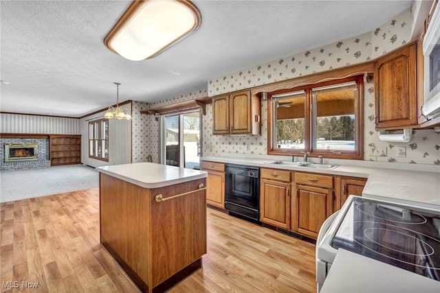 kitchen featuring a kitchen island, sink, black dishwasher, hanging light fixtures, and stainless steel range with electric cooktop