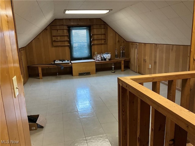 additional living space with wooden walls and lofted ceiling