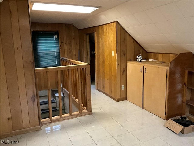 bonus room featuring wood walls and vaulted ceiling