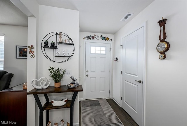 doorway to outside with dark wood-type flooring