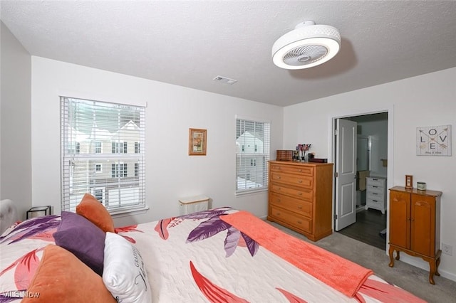 carpeted bedroom with a textured ceiling