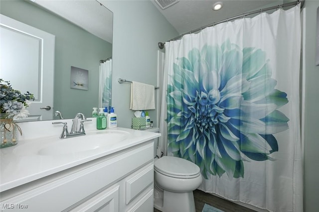 bathroom with toilet, vanity, a shower with curtain, and hardwood / wood-style floors