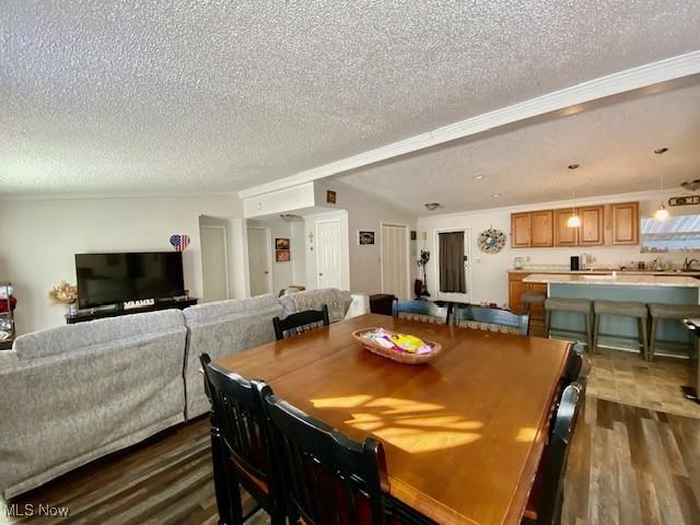 dining space featuring a textured ceiling and dark hardwood / wood-style flooring