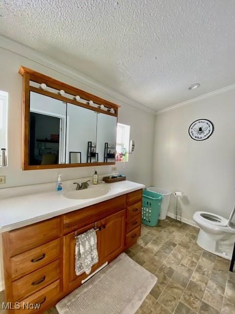 bathroom featuring a textured ceiling, toilet, vanity, and crown molding