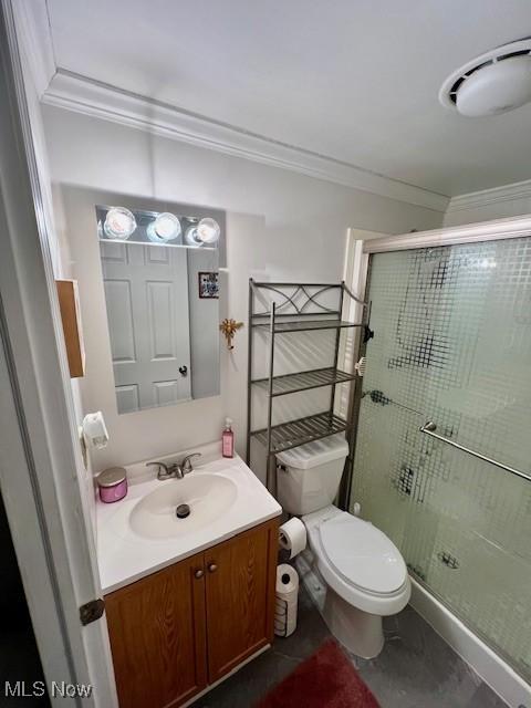 bathroom with toilet, vanity, walk in shower, and crown molding