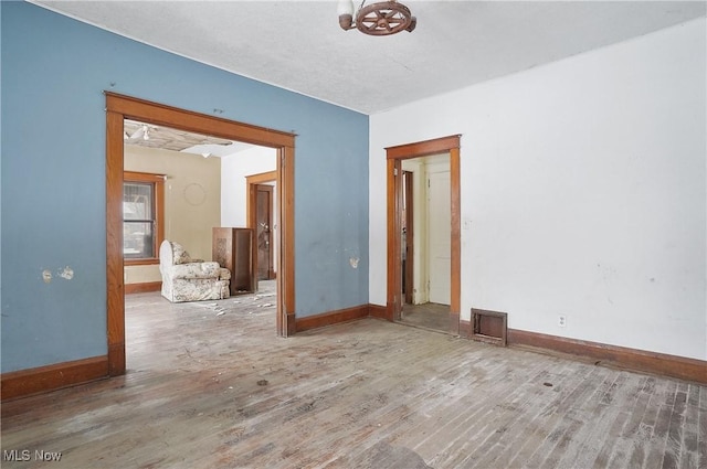 empty room with hardwood / wood-style flooring