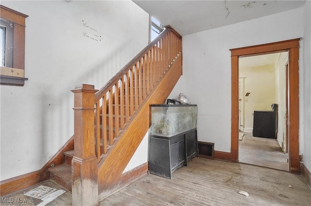 stairs featuring hardwood / wood-style flooring