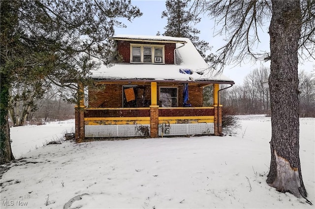 snow covered house with a porch