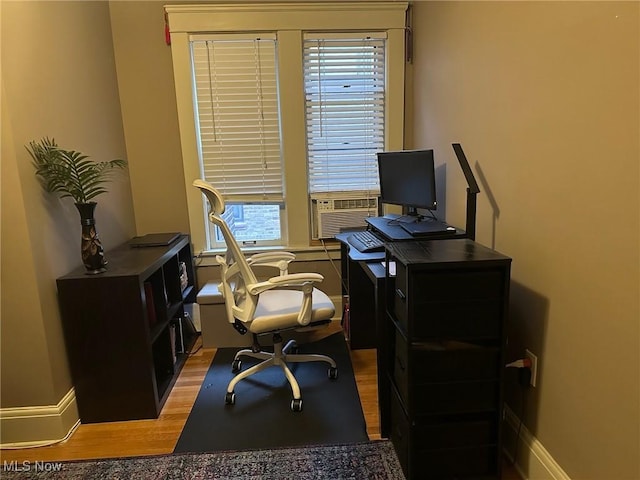 office area featuring wood-type flooring, a wealth of natural light, and cooling unit