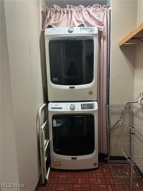 laundry room with stacked washer and dryer