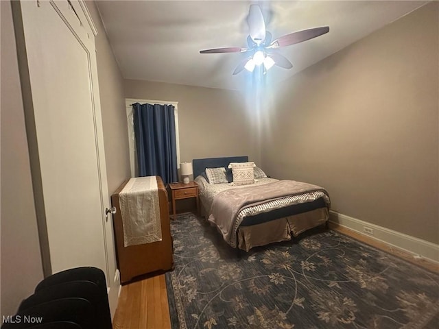 bedroom with ceiling fan and dark hardwood / wood-style flooring