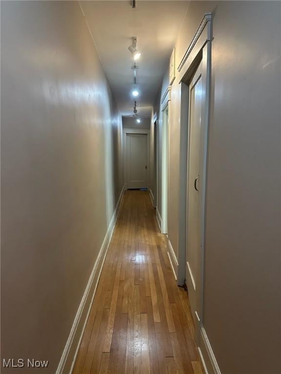 hallway with hardwood / wood-style flooring