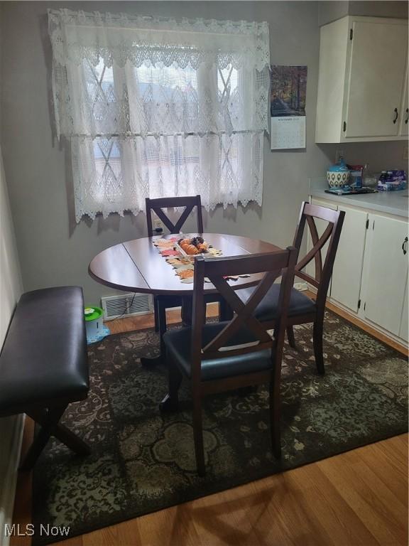 dining space featuring wood-type flooring