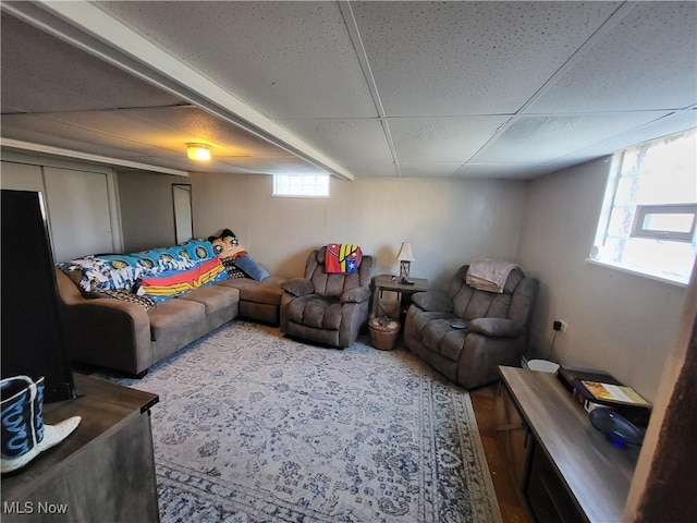 living room featuring a paneled ceiling