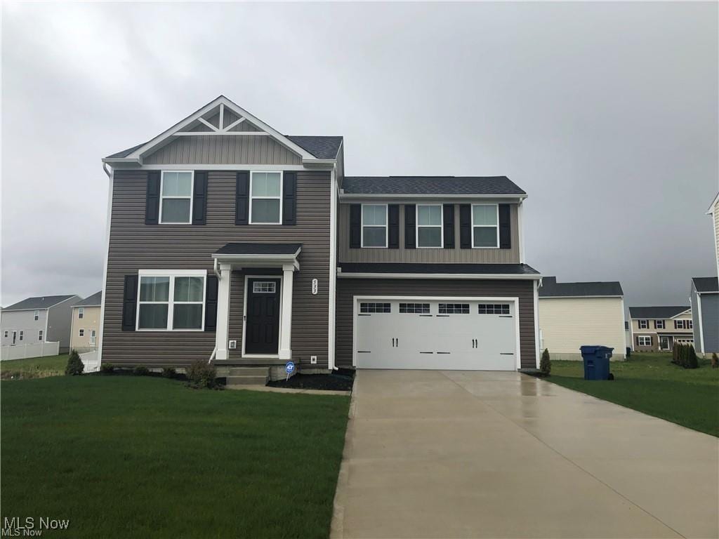 view of front of home with a front lawn and a garage