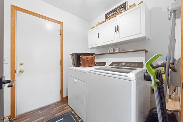 laundry room featuring dark hardwood / wood-style flooring, cabinets, and washer and dryer