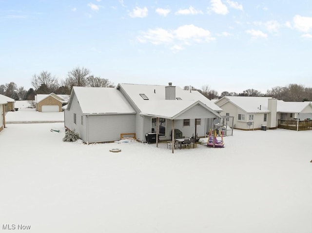 view of snow covered rear of property