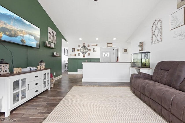 living room featuring lofted ceiling and dark hardwood / wood-style flooring