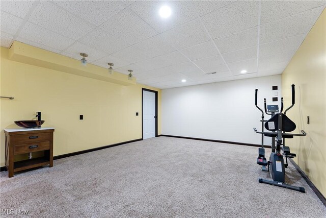 workout area with light carpet and a drop ceiling