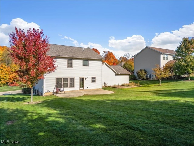 rear view of property featuring a patio area and a lawn