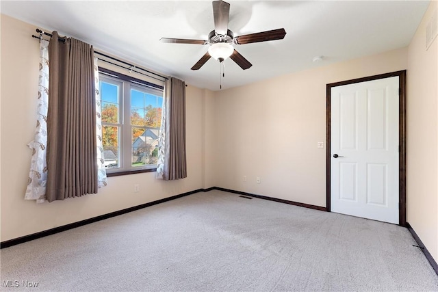 empty room with light carpet and ceiling fan