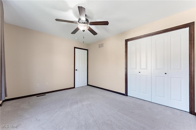 unfurnished bedroom featuring ceiling fan and light colored carpet