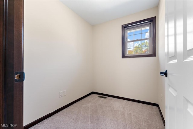 unfurnished room with light colored carpet