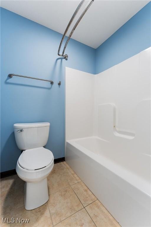 bathroom with toilet and tile patterned floors