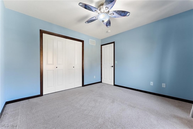 unfurnished bedroom featuring ceiling fan and light carpet