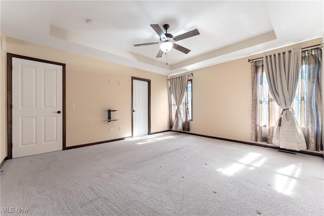 interior space featuring ceiling fan and a tray ceiling