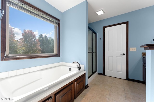 bathroom featuring plus walk in shower and tile patterned flooring