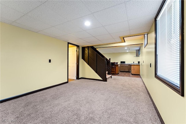 basement featuring light colored carpet