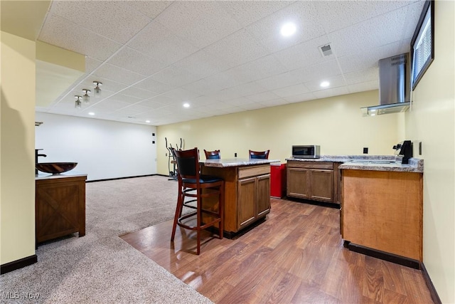 bar featuring ventilation hood, dark hardwood / wood-style floors, and stove