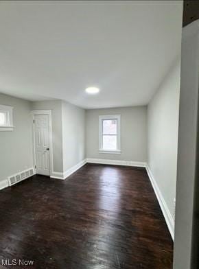 spare room featuring dark hardwood / wood-style floors