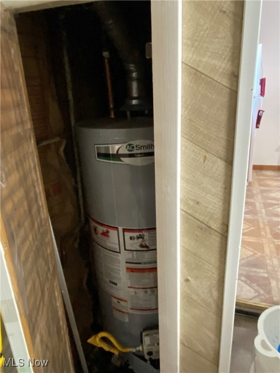 utility room with gas water heater