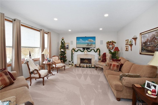 living room featuring recessed lighting, light colored carpet, a fireplace, and visible vents