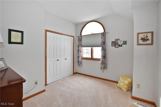 bedroom featuring a closet, light carpet, visible vents, and baseboards