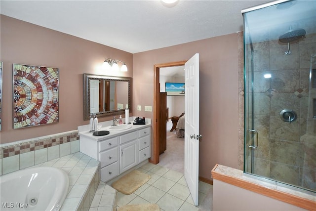 full bath featuring connected bathroom, vanity, a jetted tub, a shower stall, and tile patterned floors